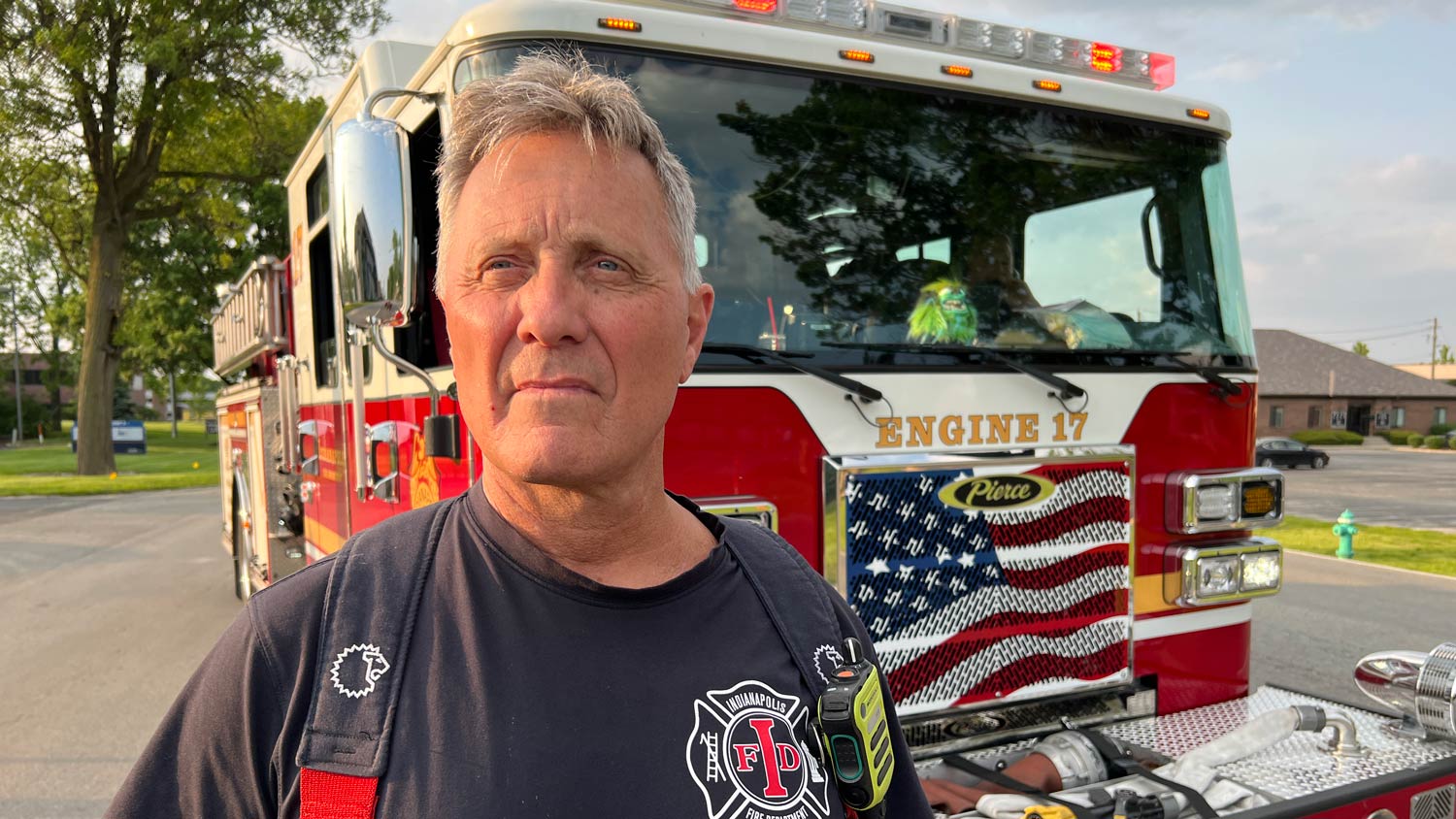 IFD Station 17 Captain Jeff Muszar standing in uniform in front of the fire truck